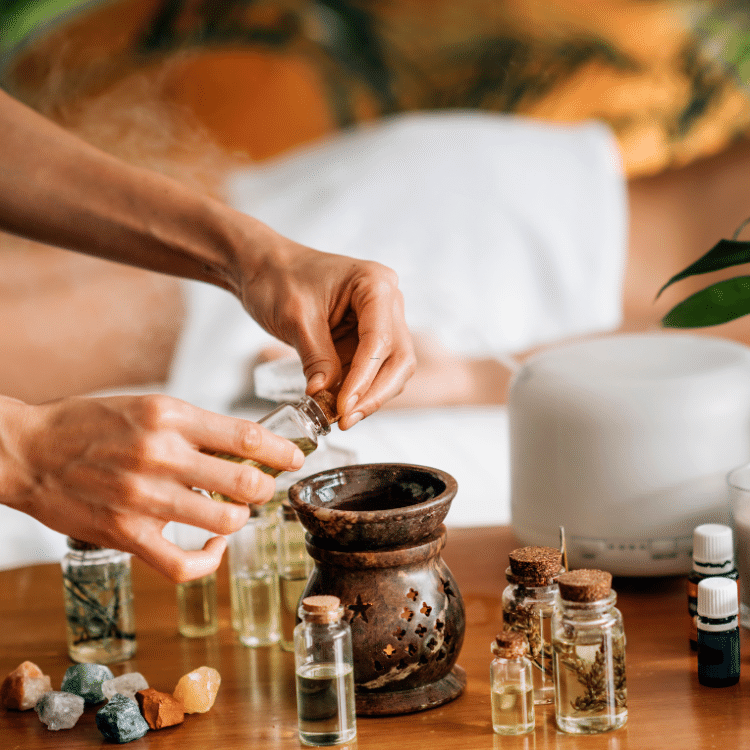 Hands blending an aromatic preparation with a mortar and pestle
