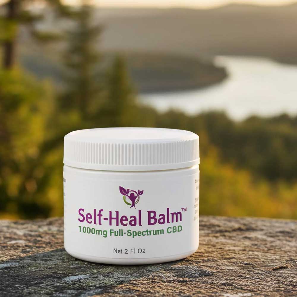 Self-Heal Balm jar labeled 1000mg Full-Spectrum CBD, photographed outdoors.